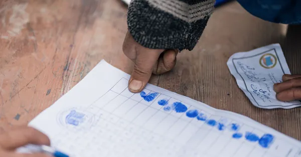 Close-up of fingerprint marking on a voting document in Afghanistan, showing election authentication. fingerprint authentication in afghanistan voting process